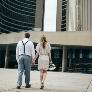 bride and groom walking up to city hall in Toronto