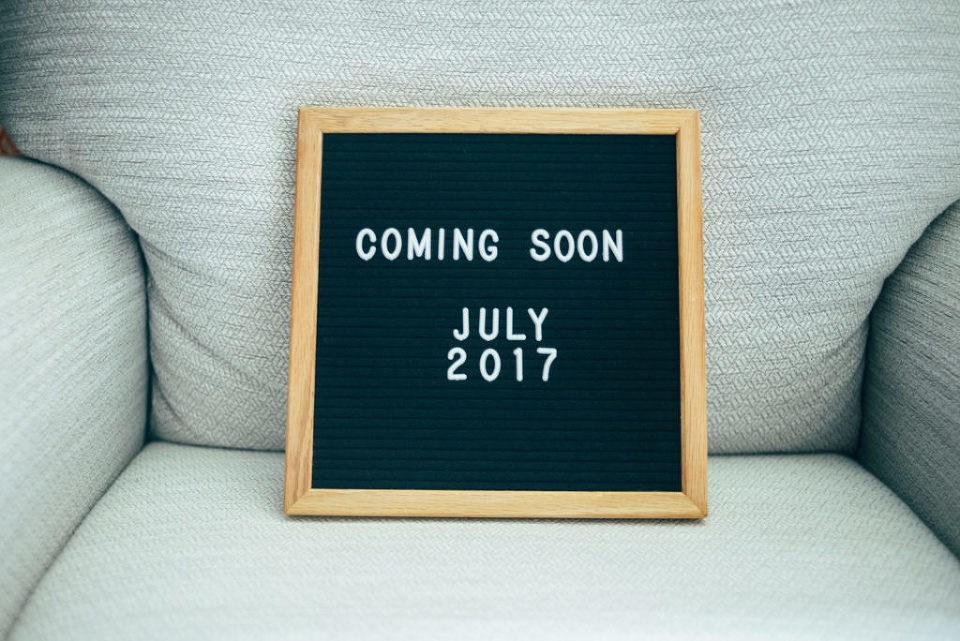 picture of a letter board sitting on a chair that says "coming soon, July 2017"