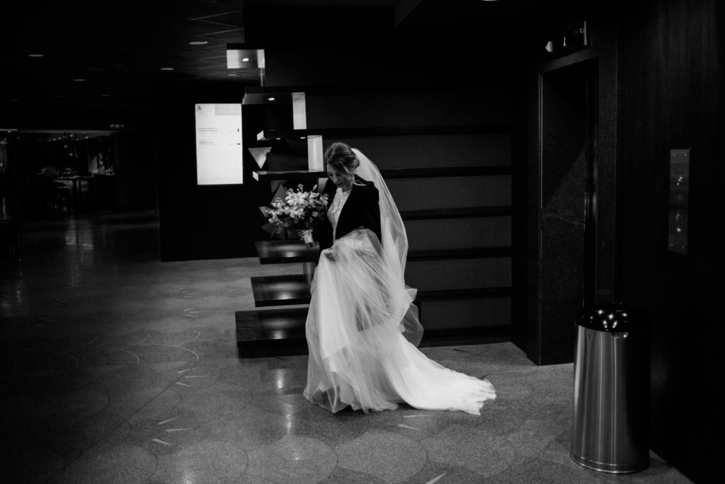 bride coming out of the elevators at the Toronto Marriott City Centre hotel