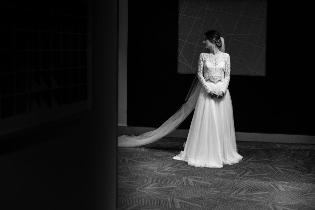 black and white portrait of the bride in her two piece wedding dress and veil