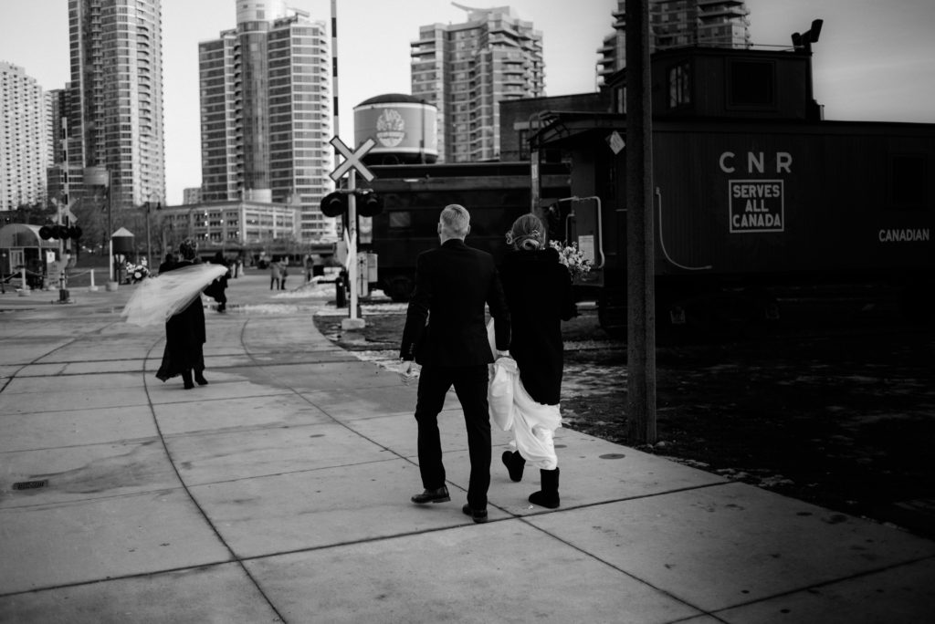 bride and groom walking to the Steam Whistle brewery in Toronto for their wedding