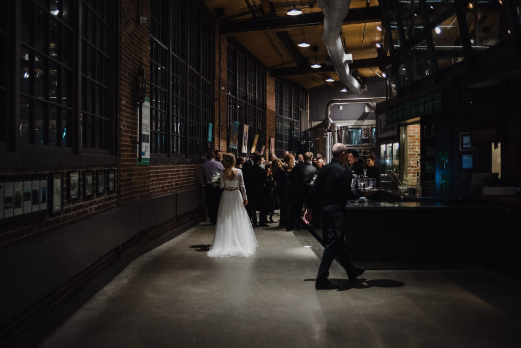 the back of the bride's dress during cocktail hour at steam whistle brewery in toronto, ontario